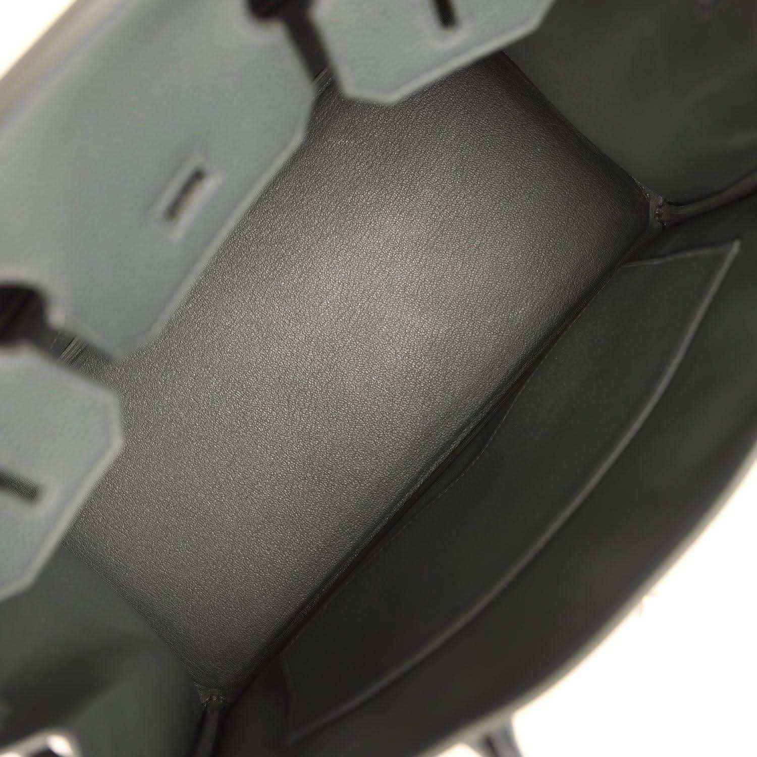 Green leather handbag interior with smooth lining and stitched corner seams