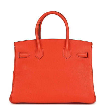 Orange Birkin handbag front view with textured leather and top handles, no lock visible