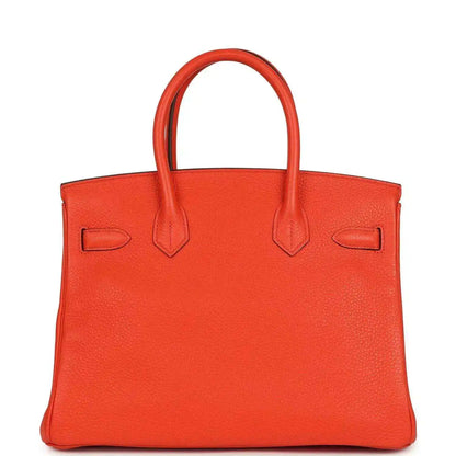 Orange Birkin handbag front view with textured leather and top handles, no lock visible