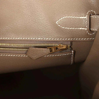 Etoupe leather Birkin 30 interior pocket with gold zipper pull and stitched trim