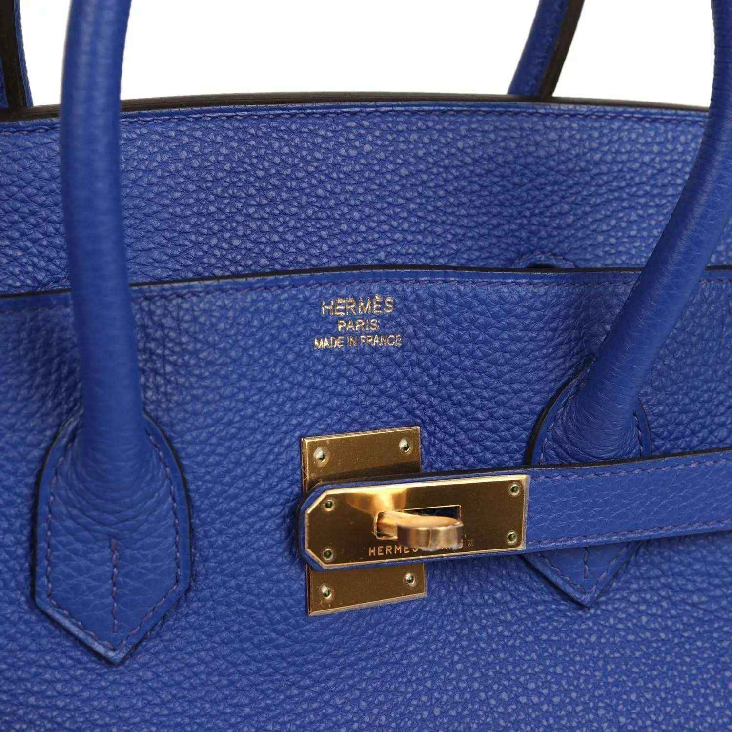 Hermes Birkin handbag close-up: gold turn-lock with Hermes logo plate