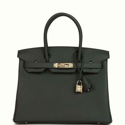 Dark green Togo leather handbag with top handles and front strap clasp