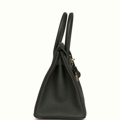 Dark green Togo leather handbag side view with dual top handles