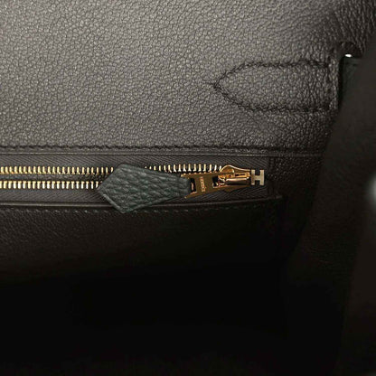 Dark green leather interior with gold zipper and stitched seam