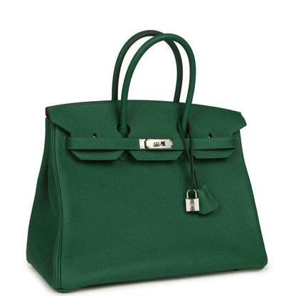 Green leather handbag with top handles and front flap featuring silver-tone lock hardware
