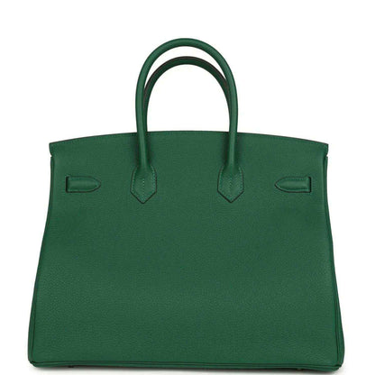 Green leather handbag with top handles and contrast stitching on front panels