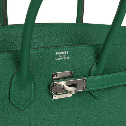 Green leather handbag with Hermes stamp and silver-tone front lock hardware