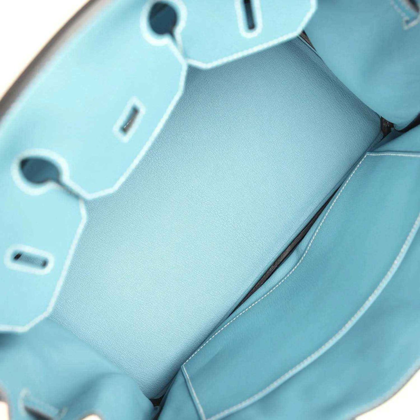 Turquoise leather interior with stitched pocket and hanging key charm tags