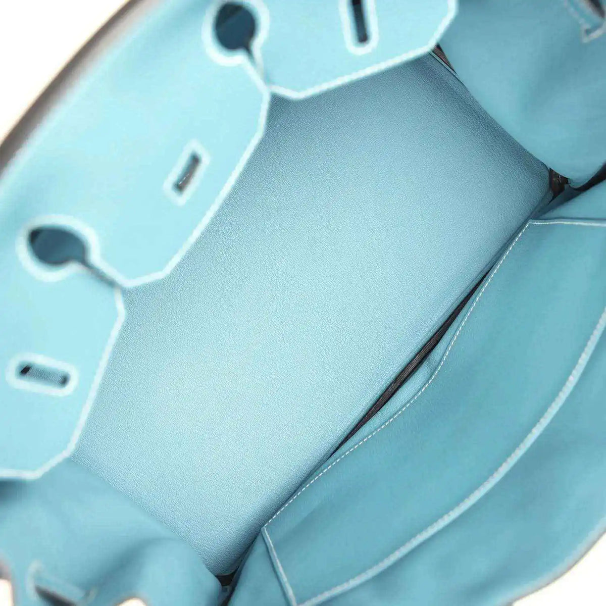 Turquoise leather interior with stitched pocket and hanging key charm tags