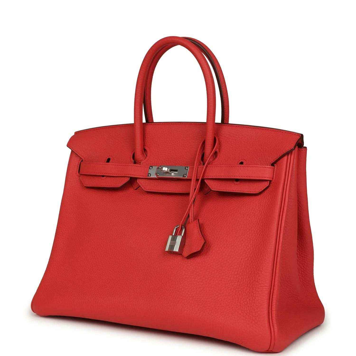 Red leather handbag with top handles, front flap pockets, and silver-tone padlock