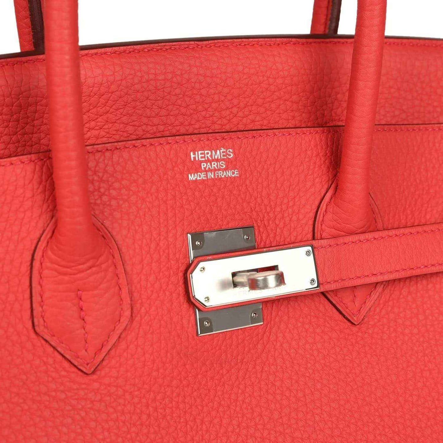 Red leather handbag with HERMÈS stamp and silver-tone clasp on interior flap