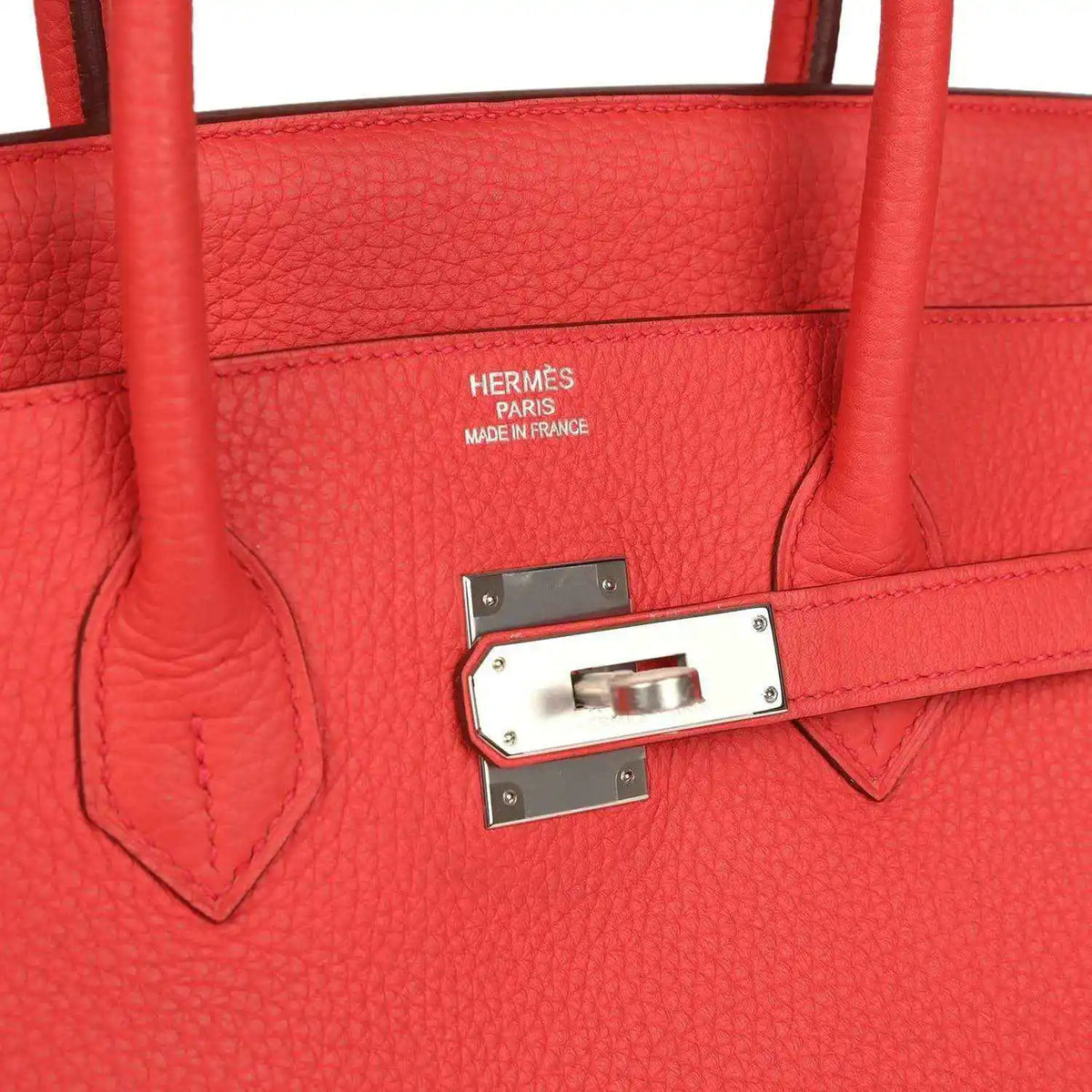 Red leather handbag with HERMÈS stamp and silver-tone clasp on interior flap