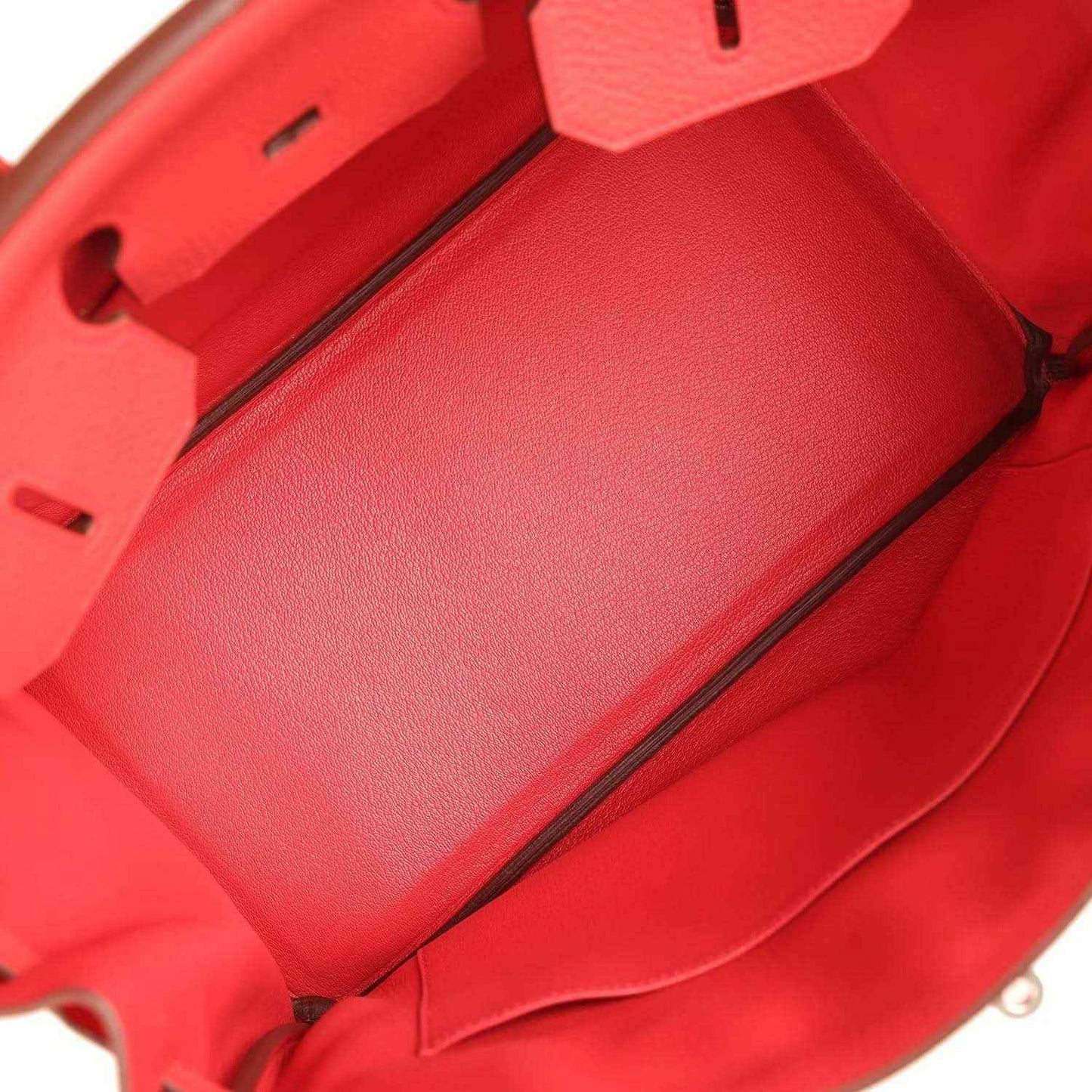Red leather handbag interior with smooth lining and front partition seam