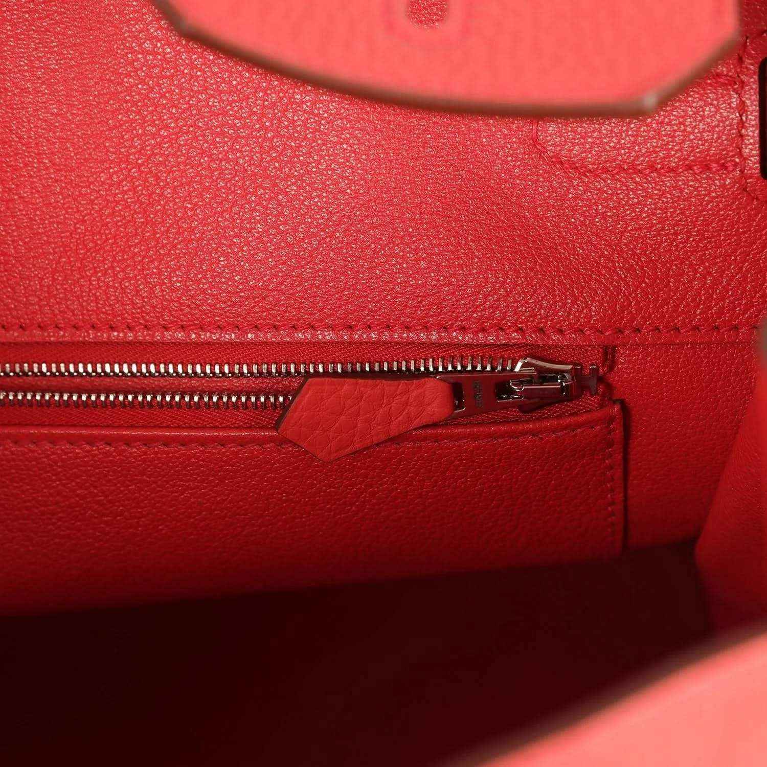 Red leather interior zip pocket with silver-tone zipper and pull tab