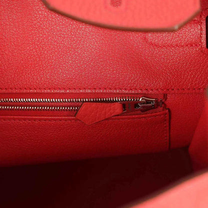 Red leather interior zip pocket with silver-tone zipper and pull tab