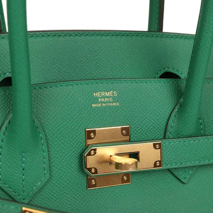 Hermès Birkin 30 green leather handbag close-up of gold clasp hardware and logo