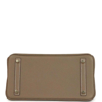 Hermes leather bag clasp close-up with gold plate and 'Hermes Paris' stamp