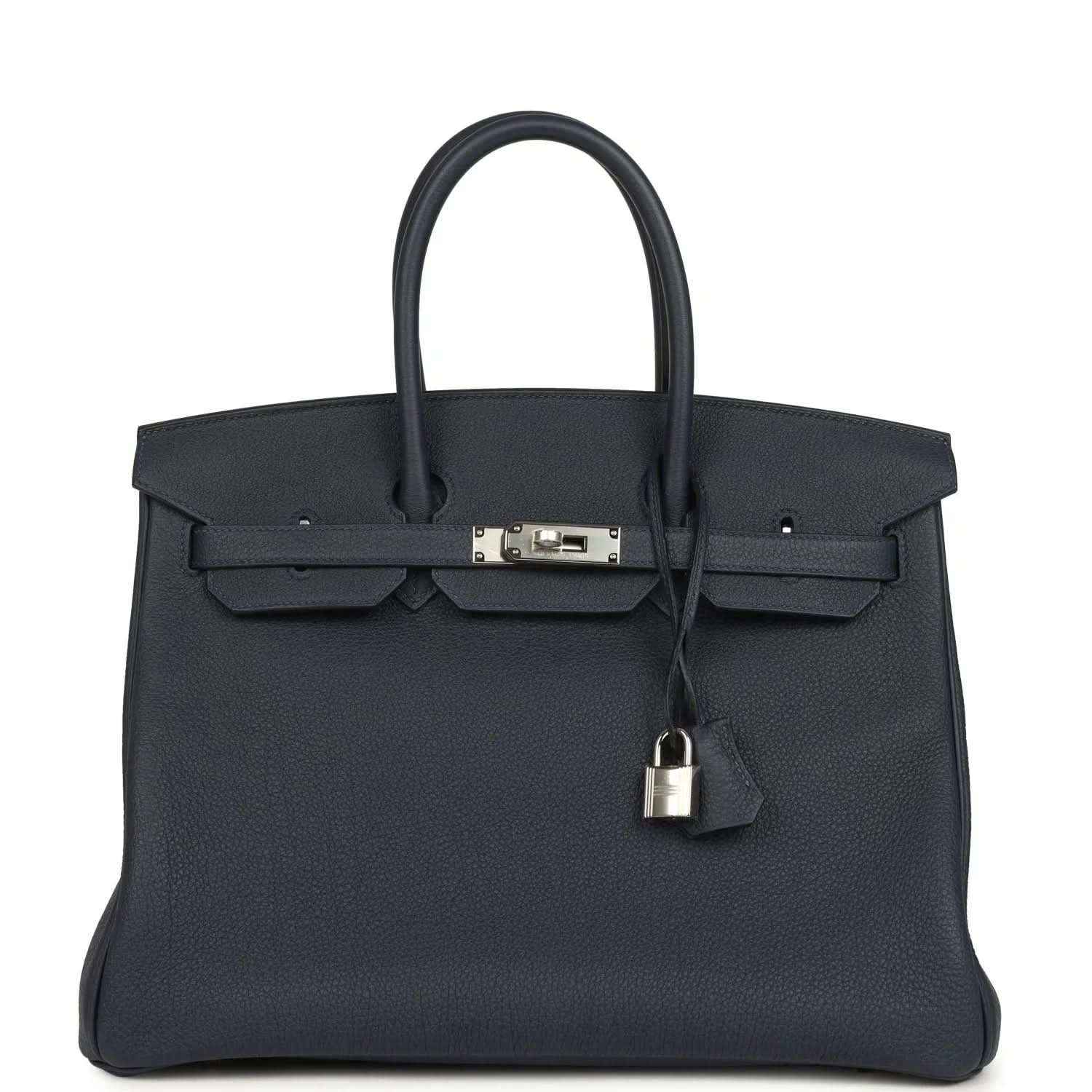 Navy leather handbag with top handle, front flap, and palladium-toned clasp