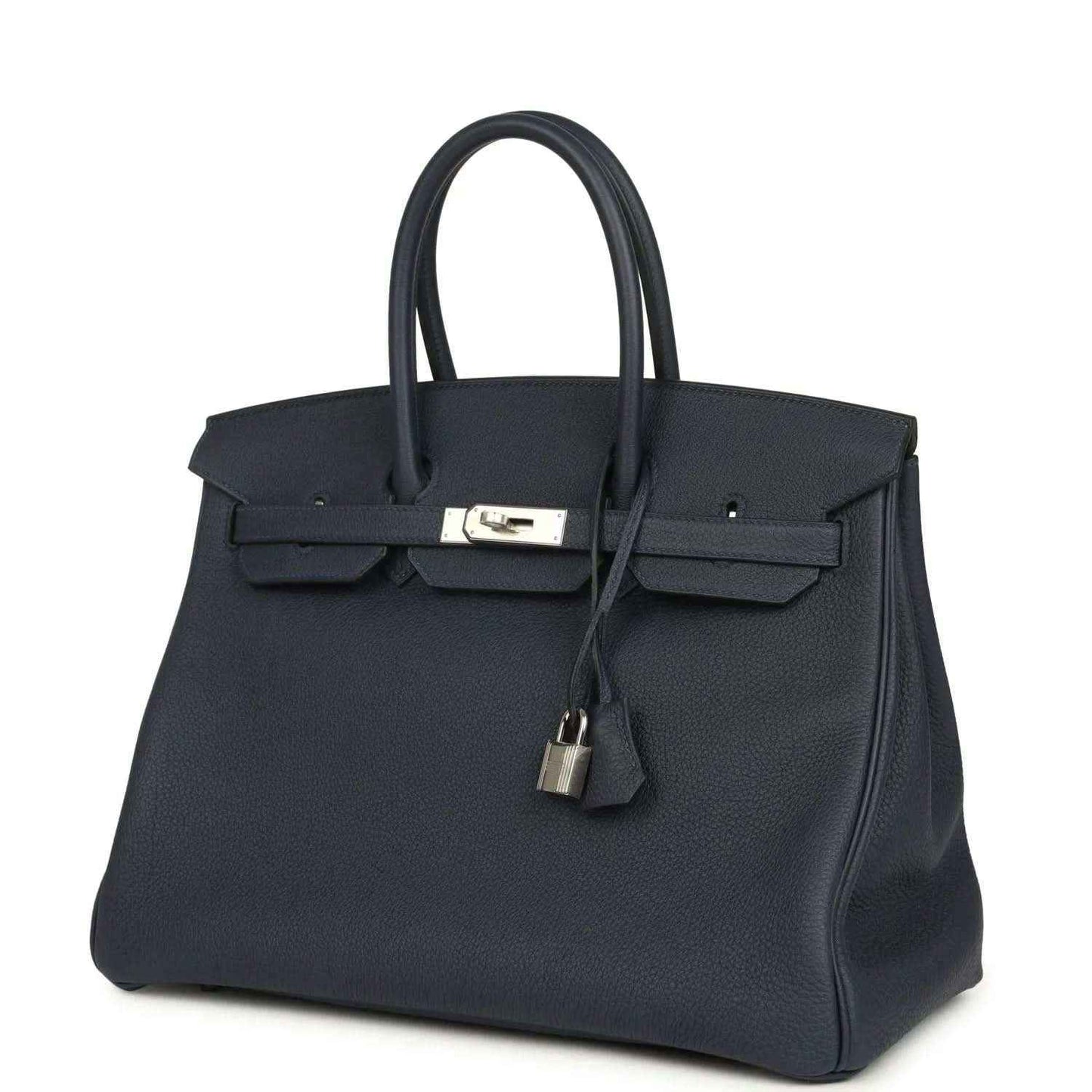 Navy leather handbag with front flap, top handles, and hanging padlock