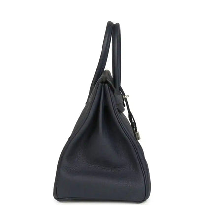 Navy leather handbag with top handles and metal strap detail