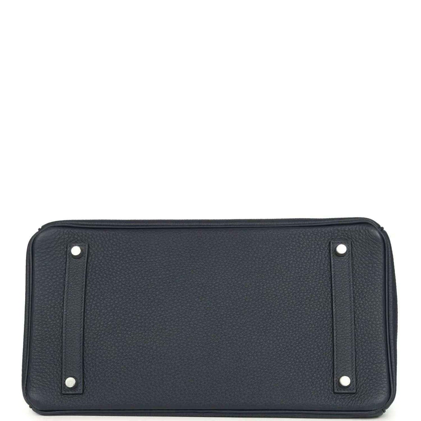Navy leather handbag front panel with corner studs and top trim