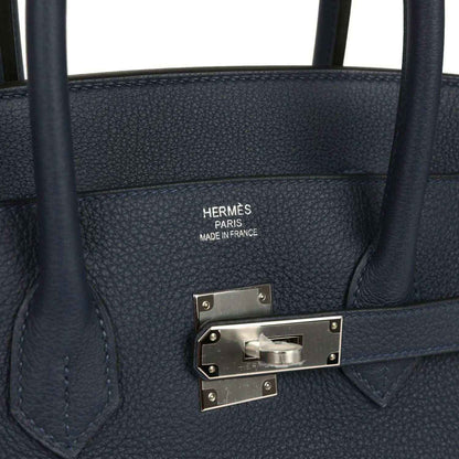 Navy leather handbag with Hermes Paris stamp and palladium-toned front clasp