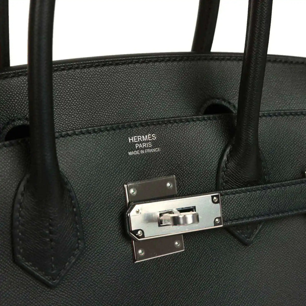 Black leather handbag interior stamp with front clasp hardware and straps