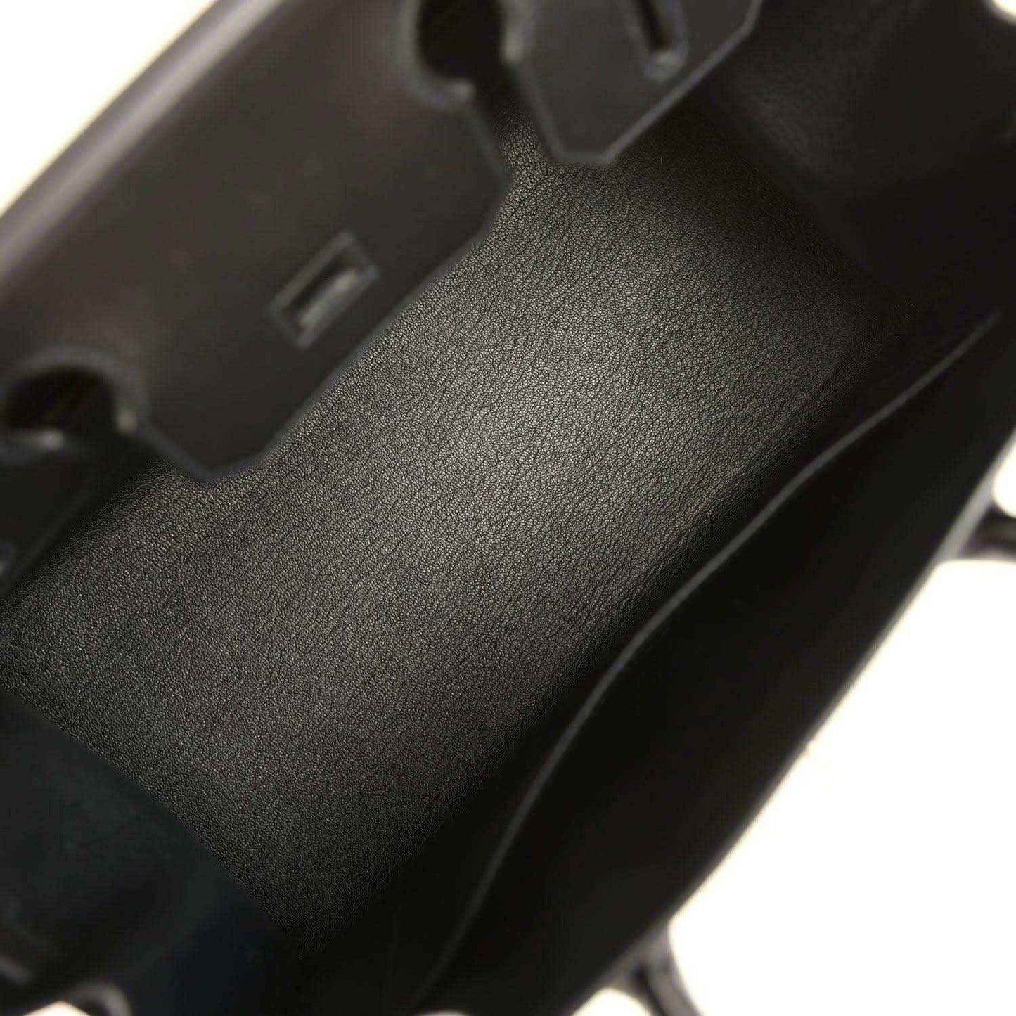 Black leather handbag interior with textured finish and interior compartment wall