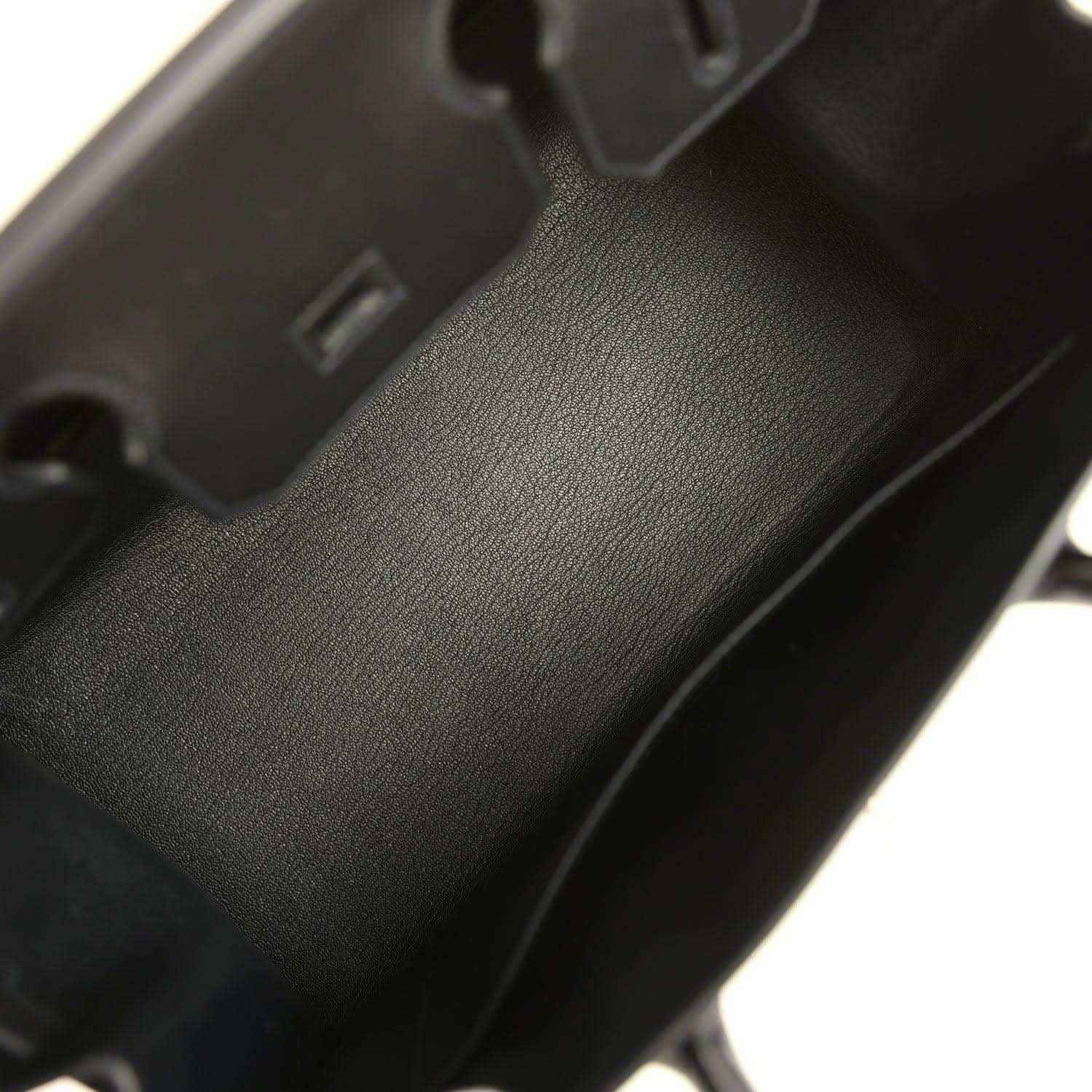 Black leather handbag interior with textured finish and interior compartment wall