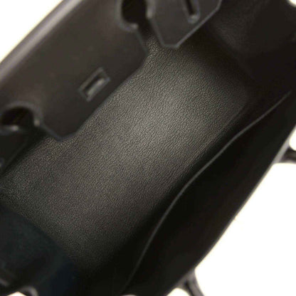 Black leather handbag interior with textured finish and interior compartment wall