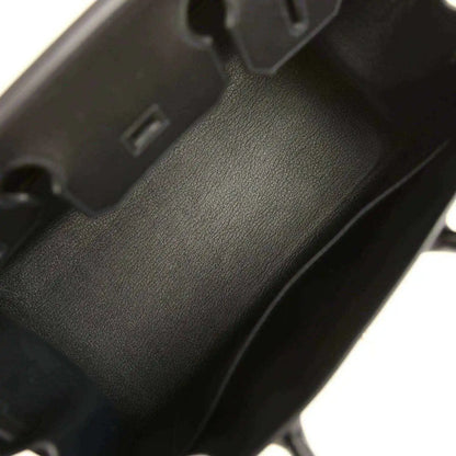 Black leather handbag interior with textured finish and interior compartment wall