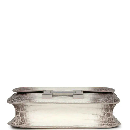 Constance-style handbag underside view with croc-embossed leather and palladium turn-lock plate