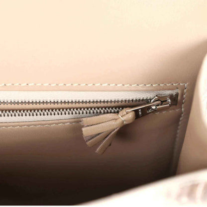 Constance-style bag interior close-up with zipper, metal pull, and tassel detail