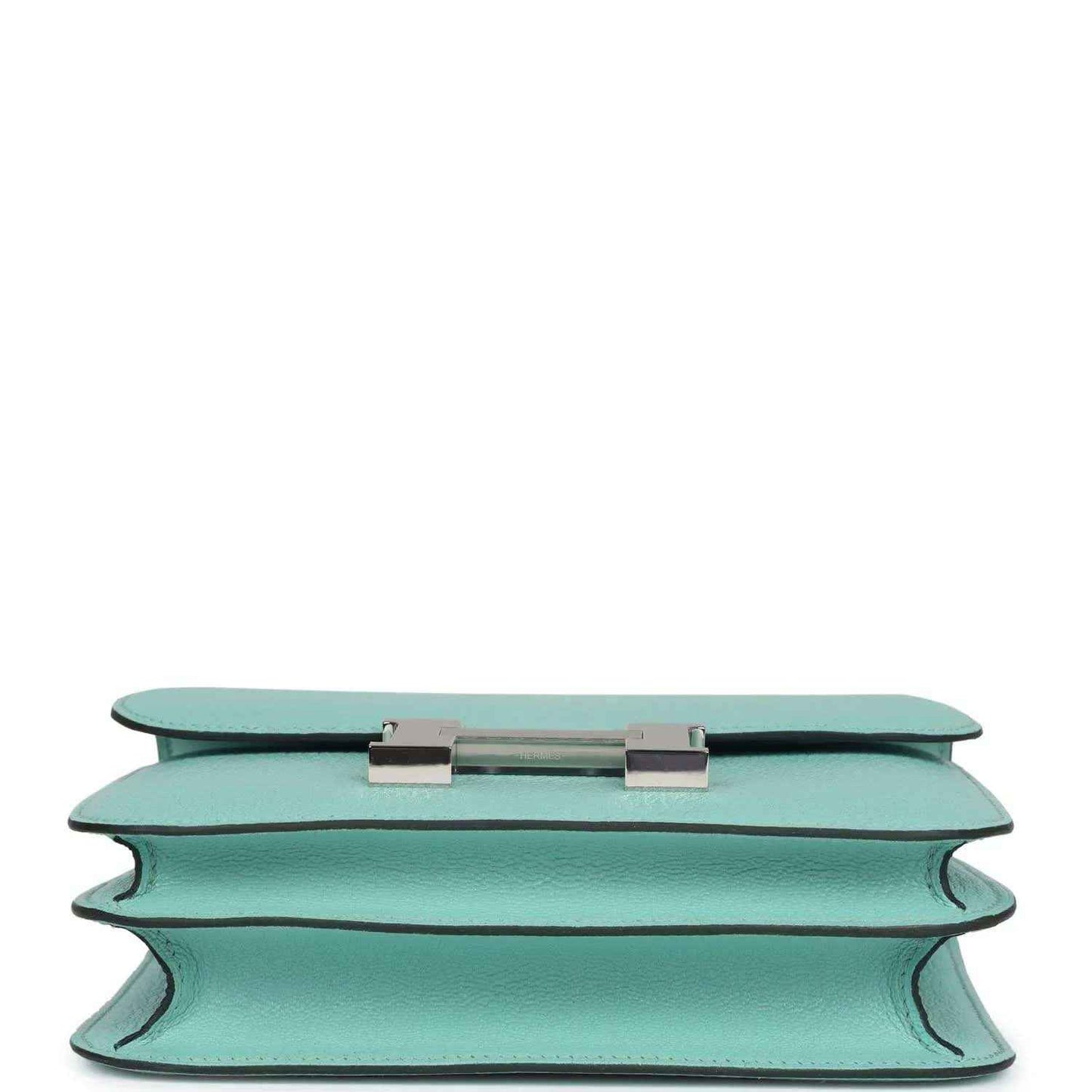 Aqua leather handbag top edge with turn-lock closure hardware