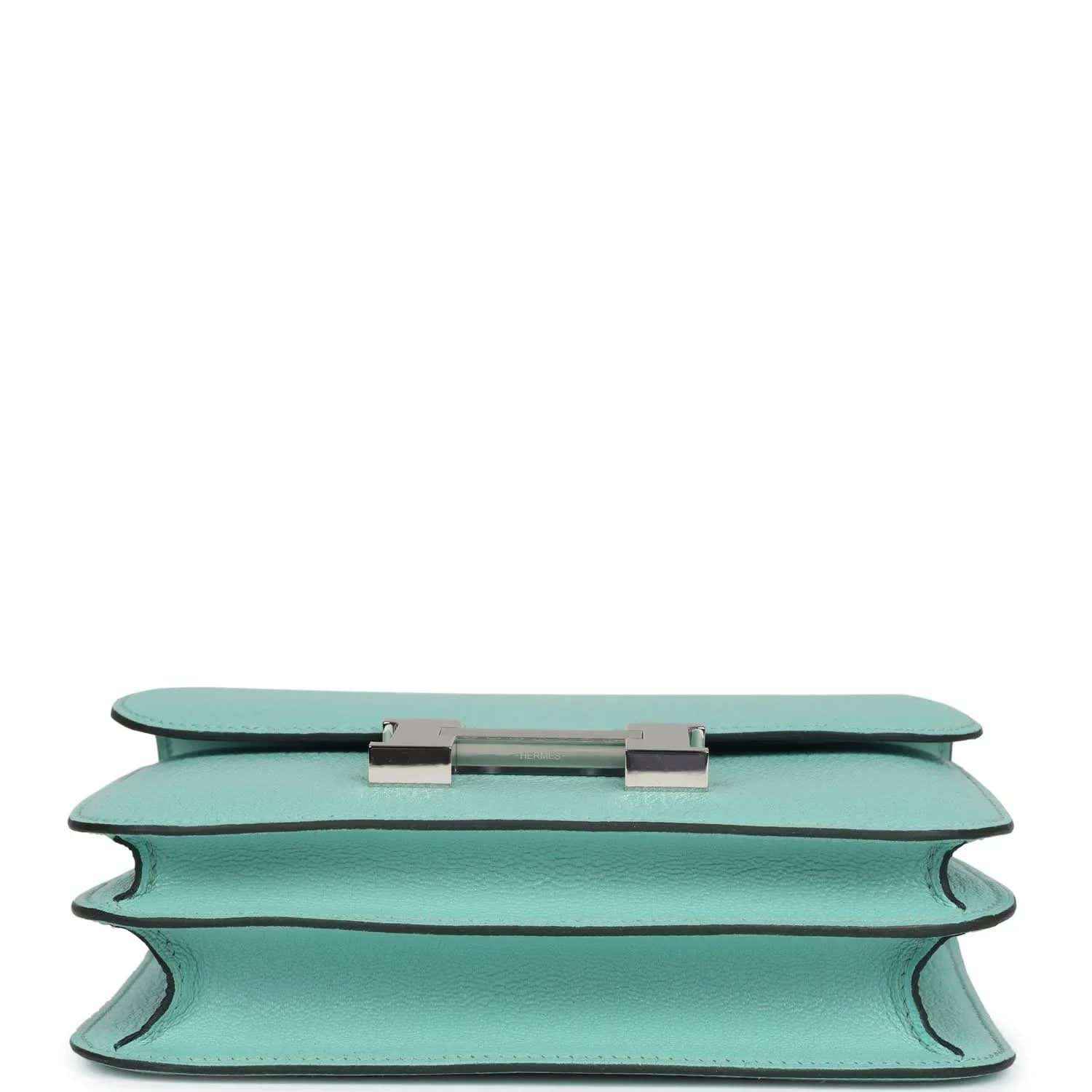 Aqua leather handbag top edge with turn-lock closure hardware