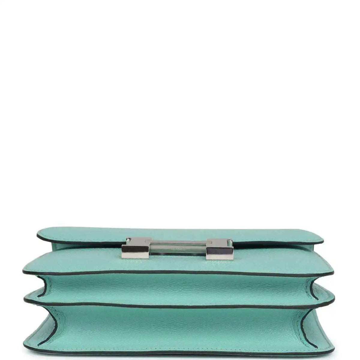 Aqua leather handbag top edge with turn-lock closure hardware