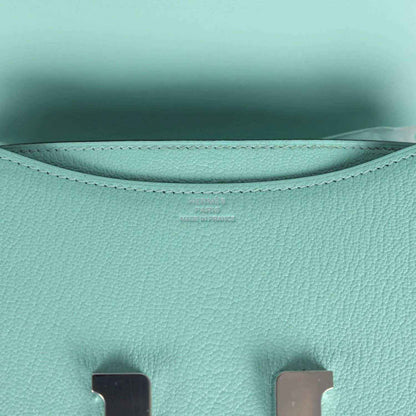 Aqua leather interior lining with curved seams and stitched top edge