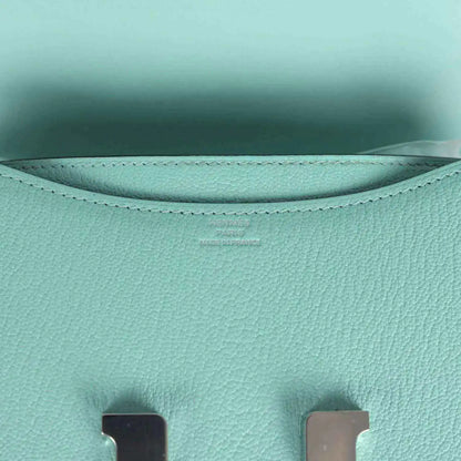 Aqua leather interior lining with curved seams and stitched top edge