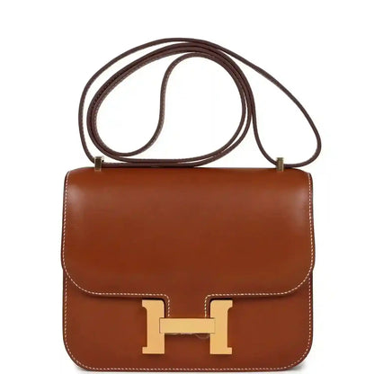 Brown leather Constance-style handbag with gold H clasp and top handle strap