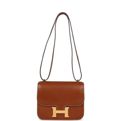 Brown leather crossbody handbag with top handles and gold H clasp