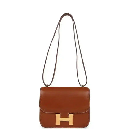 Brown leather crossbody handbag with top handles and gold H clasp