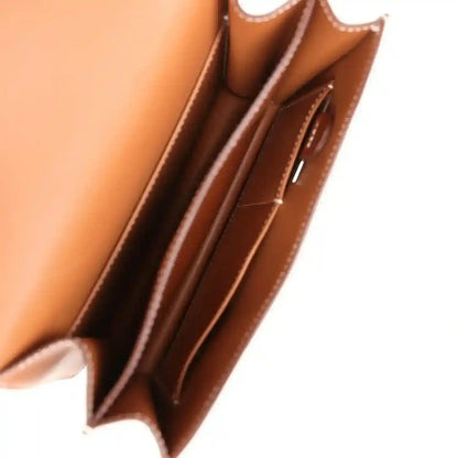 Brown leather handbag interior with stitched pockets and side lining details