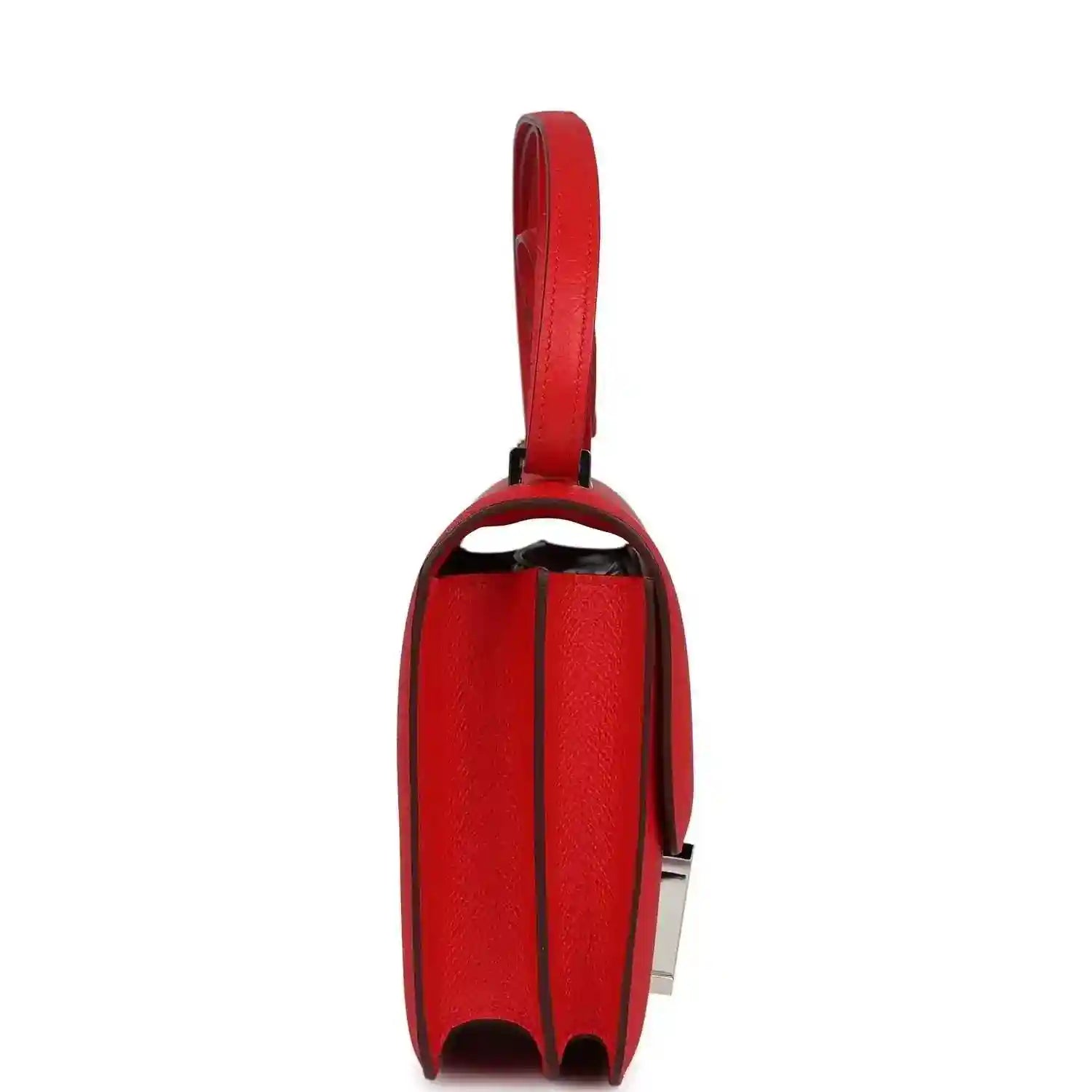 Red leather mini handbag side view with flap edge and strap