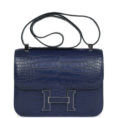 Blue alligator-effect handbag with top handle, front flap, and palladium H clasp