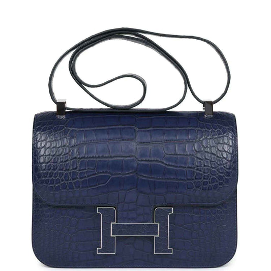 Blue alligator-effect handbag with top handle, front flap, and palladium H clasp