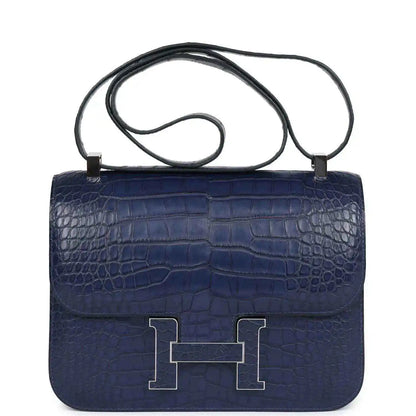 Blue alligator-effect handbag with top handle, front flap, and palladium H clasp