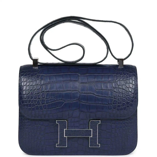 Blue alligator-effect handbag with top handle, front flap, and palladium H clasp