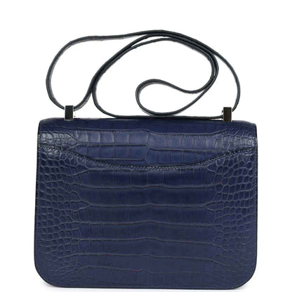 Blue alligator-effect handbag with top handle and plain flap back panel