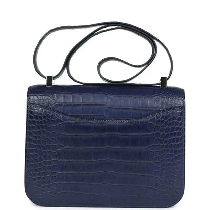 Blue alligator-effect handbag with top handle and plain flap back panel