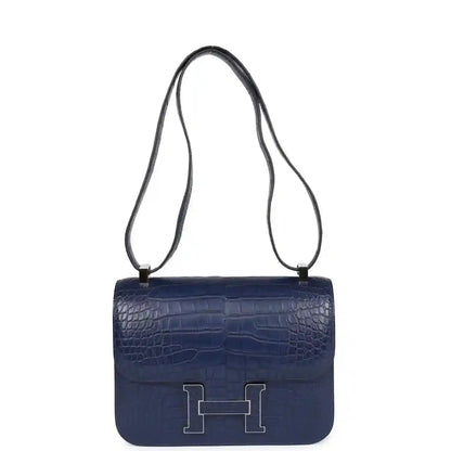 Blue alligator-effect crossbody handbag with long strap and front flap H clasp